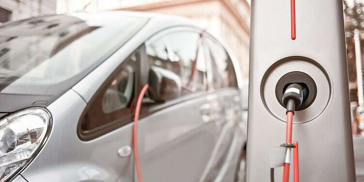 An EV charges at a streetside station Forecast: EV sales in Israel will double in 2021