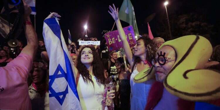 Israelis celebrate the swearing in of the new government in Jerusalem, June 13, 2021 Israelis celebrate new government after vote confirms end of Netanyahu era