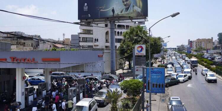 Drivers wait in a long line to get fuel at a gas station in the southern suburbs of Beirut on June 27, 2021 Lebanon increases fuel prices by more than 35% amid crisis