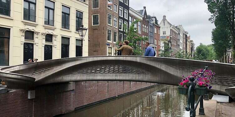 A steel 3D-printed pedestrian bridge spans a canal in the heart of the red light district in Amsterdam, Netherlands, July 15, 2021 Dutch queen, robot dedicate 3D-printed bridge in Amsterdam