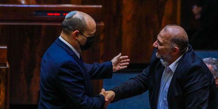 Prime Minister Naftali Bennett shakes hands with Ra'am party chief Mansour Abbas in the Knesset, June 28, 2021 Bennett's government has to pay the piper