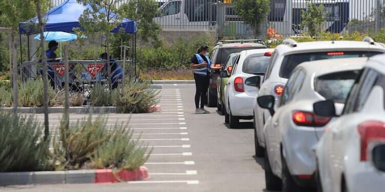 A lline of cars is seen at a drive-thru coronavirus testing site outside of Modiin, June 23, 2021 Active COVID cases surpass 10,000 for first time in 4 months