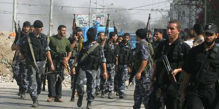 Members of Hamas' security forces and members of Hamas' armed militant wing, the Izzedine al-Qassam Brigades, move through the streets in Gaza City Hamas security forces kill 2, EU 'appalled'