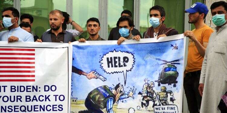 Former Afghan interpreters hold banners during a protest against the US government in Kabul, Afghanistan, April 30, 2021 US to begin evacuating Afghans who aided American military