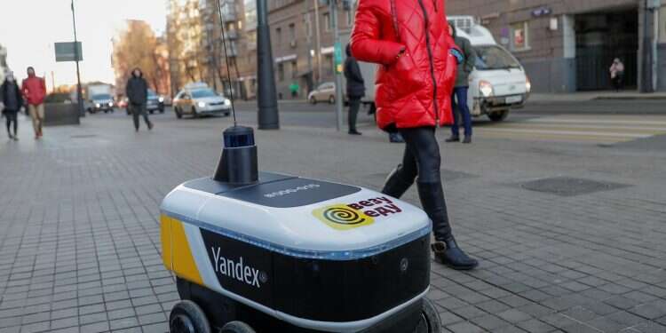 The Yandex Rover, a driverless robot for delivering hot restaurant meals, is seen at a business district in Moscow on Dec. 10, 2020 Driverless robots from Russia's Yandex to deliver food to US colleges via GrubHub