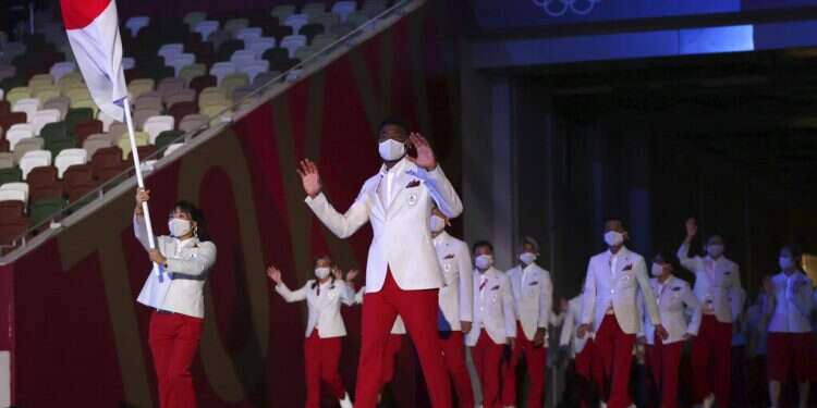 Yui Susaki and Rui Hachimura, front right, of Japan, carry their country's flag during the opening ceremony in the Olympic Stadium at the 2020 Summer Olympics in Tokyo on July 23, 2021
Japan ends Tokyo 2020 with a record 58 medals
