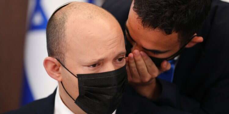 Prime Minister Naftali Bennett receives information at the weekly cabinet meeting in Jerusalem, Sunday, Aug. 1, 2021 Israeli PM blames Iran for tanker attack that killed 2