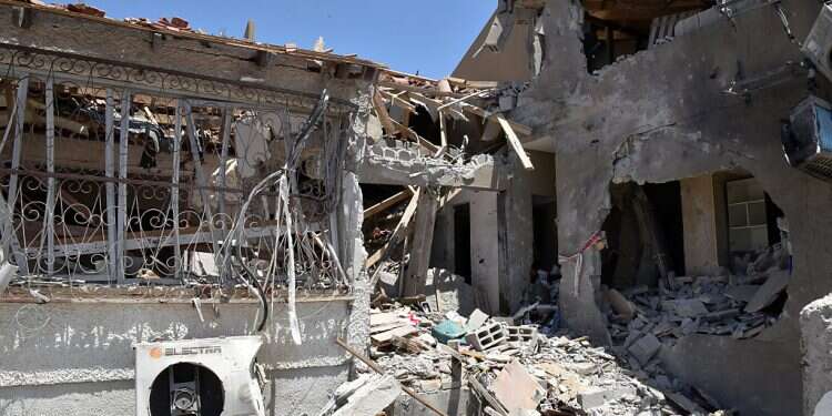 A building in Ashkelon that was destroyed by a rocket fired from the Gaza Strip during Operation Guardian of the Walls in May is seen on May 25, 2021 Why are PA banks delaying transfer of Qatari funds to Gaza?