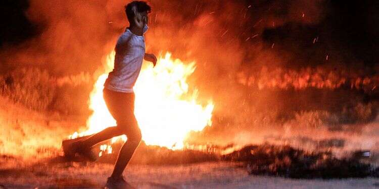 Is Israel headed toward a civil war? (Reuters/Amar Awwad) Hundreds of Gazans burn tires, lob explosives as border riots continue