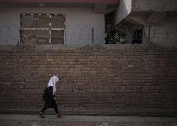 A girl walks to school before class in Kabul, Afghanistan, Sept. 12, 2021 Taliban says will allow women to study in gender-segregated universities