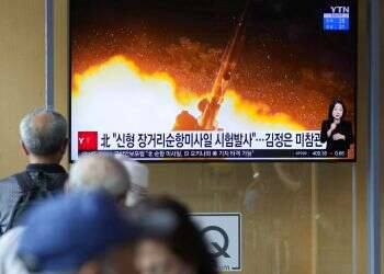 People watch a newscast showing the long-range cruise missiles tests in Seoul, South Korea, Sept. 13, 2021 North Korea tests new long-range cruise missiles