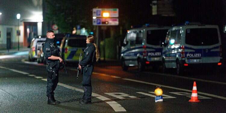 Police officers block a street in the city center during a police operation protecting the Jewish Community building in Hagen, Germany, Sept. 16, 2021 Report: German police foil attack on synagogue during Yom Kippur
