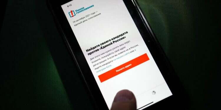 The app Smart Voting is displayed on an iPhone screen in Moscow, Russia, on Sept. 17, 2021 Apple, Google comply with Russian request to remove political opposition app