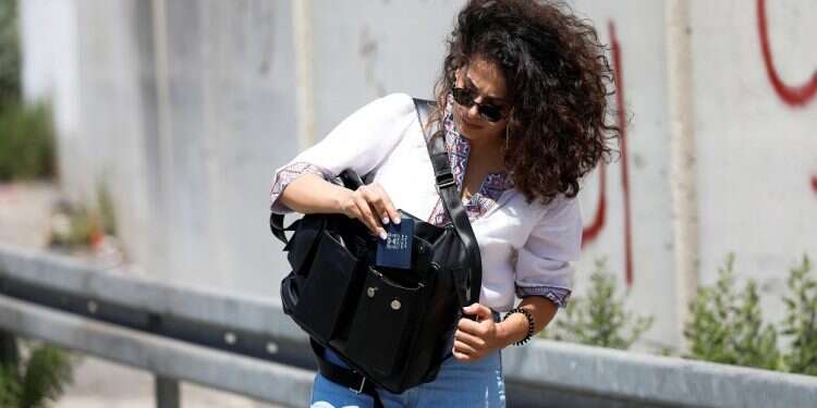 Areej Ashhab with her Checkpoint bag, August 30, 2021 Palestinian woman designs special bag to use at Israeli checkpoints