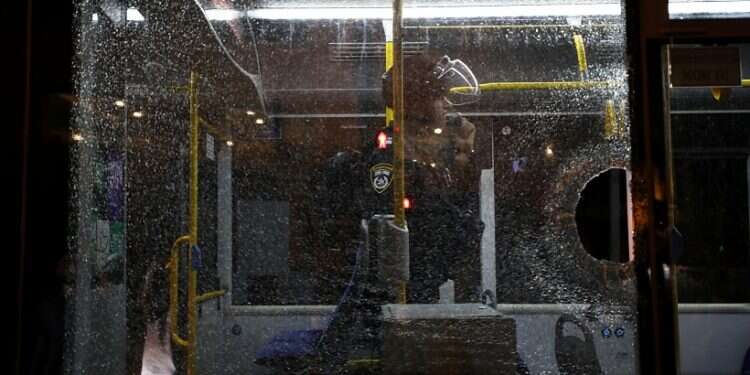 An Israeli police officer inside a bus damaged during clashes with Palestinian rioters near Damascus Gate in Jerusalem, Wednesday, Sept. 8, 2021 Palestinian prisoners riot in support of fugitive terrorists as manhunt enters 4th day