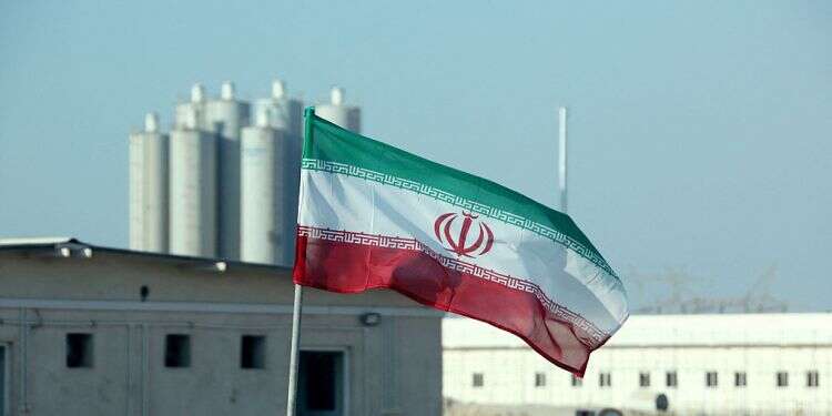 An Iranian flag flies at Iran's Bushehr nuclear power plant during an official ceremony to kick-start works on a second reactor at the facility, Nov. 10, 2019 'Iran 1 month away from breakout to nuclear weapon,' think tank warns