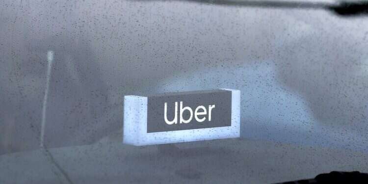 An Uber sign is displayed inside a car in Chicago on May 15, 2020
Uber drivers in Netherlands covered by taxi labor agreement, court rules