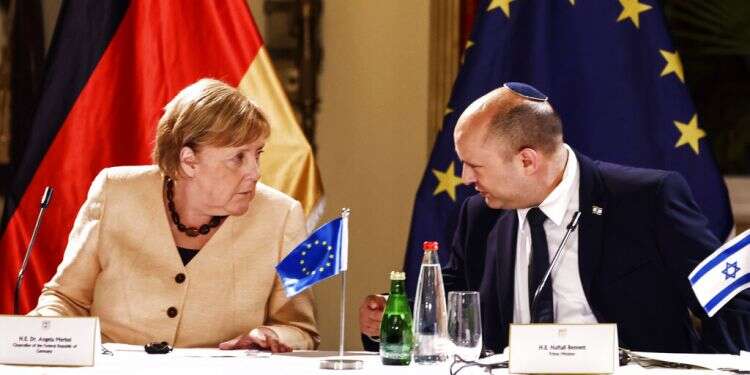 German Chancellor Angela Merkel and Prime Minister Naftali Bennett chat during a roundtable discussion with Israeli entrepreneurs, in Jerusalem, Oct. 10, 2021 Merkel: We must not lose sight of need to establish Palestinian state