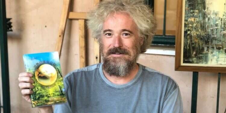 Translator Noam Aurbach holding a copy of 'The Universal Garden of Emuna' in Chinese Popular book by Breslov rabbi now available in Mandarin translation