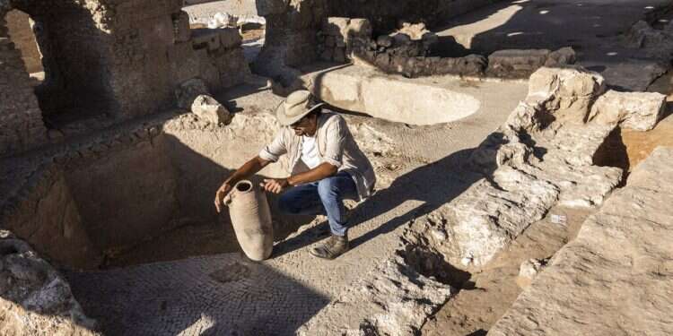 Avshalom Davidesko from the Israel's Antiquities Authority examines a jar in a massive ancient winemaking complex dating back some 1,500 years in Yavne, Oct. 11, 2021
Real vintage: Ancient complex produced 2 million liters of wine a year