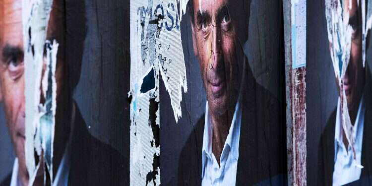 A torn poster of French far-right media pundit Eric Zemmour in Paris In France, Trump-like TV pundit rocks presidential campaign