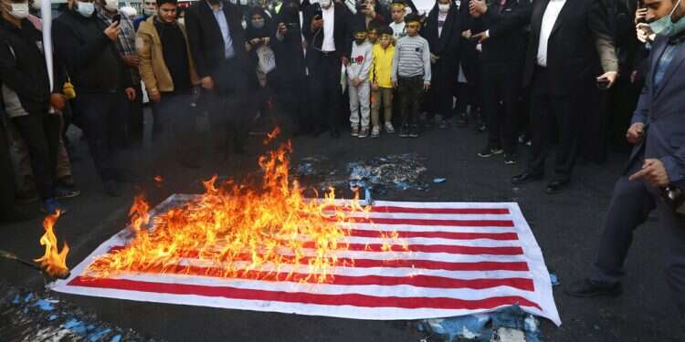 Demonstrators set fire to a mock US flag in a rally in front of the former US Embassy commemorating the anniversary of its 1979 seizure in Tehran, Iran, Thursday, Nov. 4, 2021 Iran marks anniversary of 1979 takeover of US Embassy