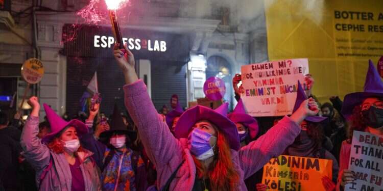 A woman holds up a flare as she marches with others during a protest marking the International Day for the Elimination of Violence against Women in Istanbul, Turkey, Nov. 25, 2021
Turkish police use tear gas against women protesting violence