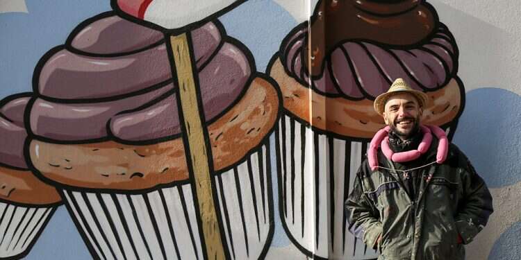 Italian street artist battles racism by turning swastikas into cupcakes