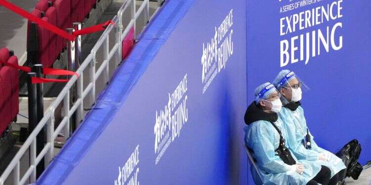 Medical personnel wearing protective equipment watch a test event for the 2022 Beijing Winter Olympics, at the Wukesong Sports Center in Beijing, Nov. 8, 2021. Foreign athletes preparing for Beijing Olympics test positive for COVID-19