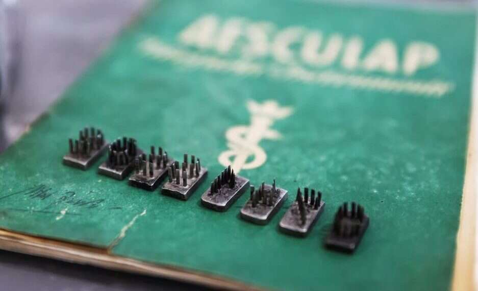 The dies from a tattoo kit, and a manual, are displayed at an Israeli auction house which says they were used on inmates at Auschwitz death camp, Nov. 2, 2021 (Reuters/Ronen Zvulun) Auction house under fire for selling Nazi tattoo kit offers compromise