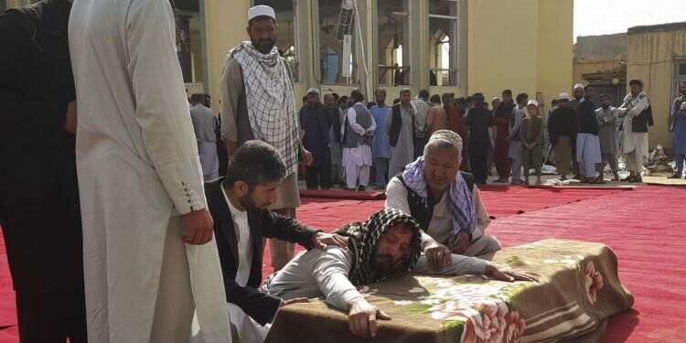 Relatives and residents attend a funeral for victims of a suicide attack at the Gozar-e-Sayed Abad Mosque in Kunduz, northern Afghanistan, Oct. 9, 2021 Targeted killings put Taliban's claims of safer Afghanistan in question