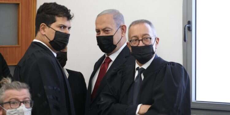 Opposition leader Benjamin Netanyahu and his legal team in the Tel Aviv District Court Netanyahu's lawyers seek probe of leaks as trial resumes