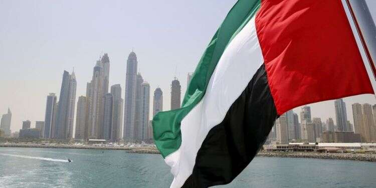 UAE flag flies over a boat at Dubai Marina Stuck in the middle? UAE walks tightrope between US, Israel and Iran