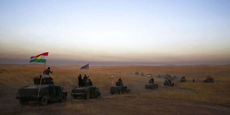 A Kurdish Peshmerga convoy drives towards a frontline in Khazer, about 30 kilometers 19 miles east of Mosul, Iraq, Oct. 17, 2016 ISIS attack on village in northern Iraq kills 13, Kurdish gov't says