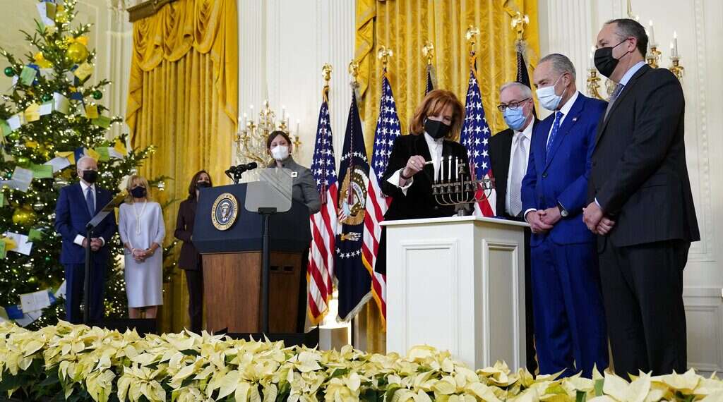 US President Joe Biden and first lady Jill Biden, left, watch as Jewish community leader Susan Stern lights a menorah in the East Room of the White House in Washington, during an event to celebrate Hanukkah, Wednesday, Dec. 1, 2021. Others participating are, from left, Vice President Kamala Harris, Rabbi Lauren Holtzblatt, Dr. Rabbi Aaron Glatt, Senate Majority Leader Chuck Schumer of NY, and second gentleman Doug Emhoff Bidens, Harris, Emhoff hold 'family' Hanukkah celebration at White House