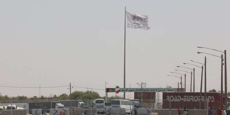 The flag of the Islamic Emirate of Afghanistan (Taliban) is pictured from the Dowqarun border crossing between Iran and Afghanistan, Razavi Khorasan Province, Iran August 29, 2021 Clashes in Iran-Afghanistan 'border misunderstanding' reportedly over