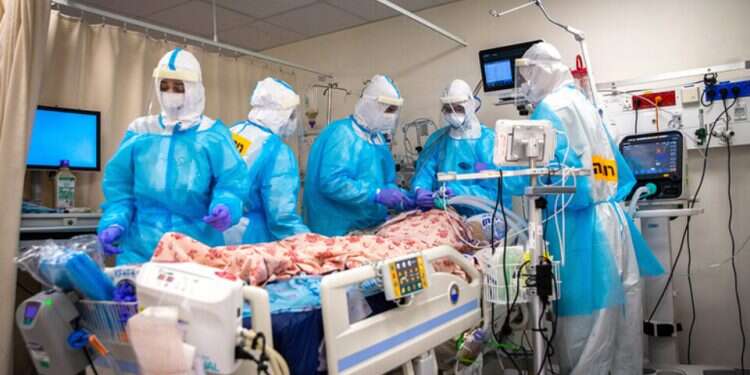Medical staff at a COVID unit care for a seriously ill patient Chief COVID Officer warns ICU units in Israel already at 'peak capacity'