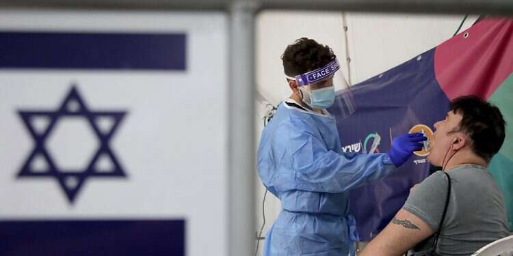 A man is tested for COVID-19 at Sheba Medical Center at Tel Hashomer on Dec. 4, 2021 Bennett: Time is up – 5th wave is here