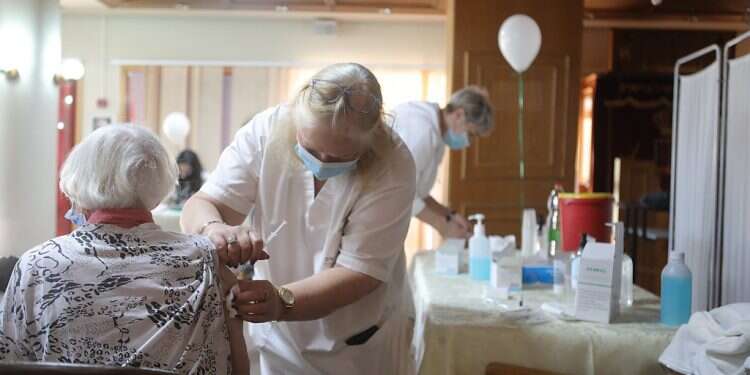 Residents of the Beit Shalom retirement home in Herzliya are vaccinated for COVID on Dec. 30, 2020. COVID has increased the isolation many elderly already experience 'Loneliness kills, and should be treated like a disease in every respect'