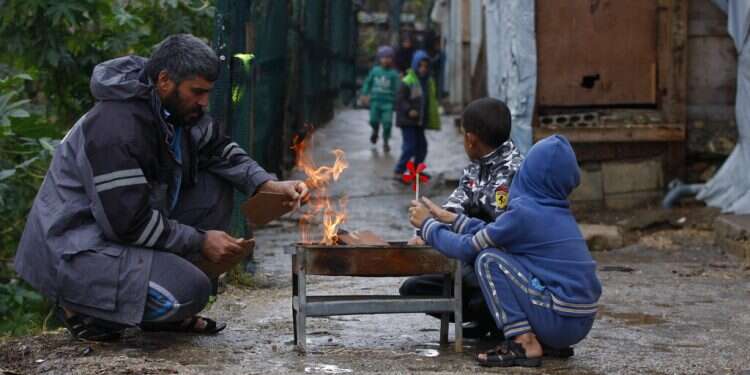 A displaced Syrian family warms themselves around a fire at a refugee camp in the southern port city of Sidon, Lebanon, on Jan. 19, 2022
Lebanon, Syria's poorest citizens struggle to stay warm in snowstorm