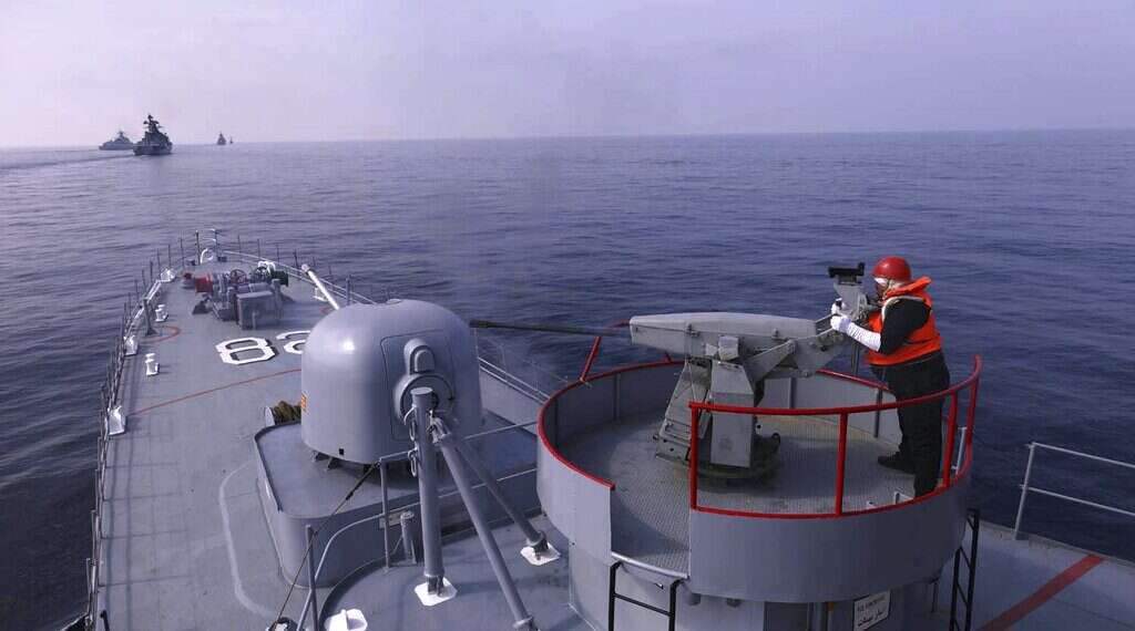 In this photo provided Jan. 21, 2022, by the Iranian Army, an Iranian army member fires a weapon during a joint naval drill of Iran, Russia and China in the Indian Ocean
Iran, Russia and China begin naval drill to boost marine security