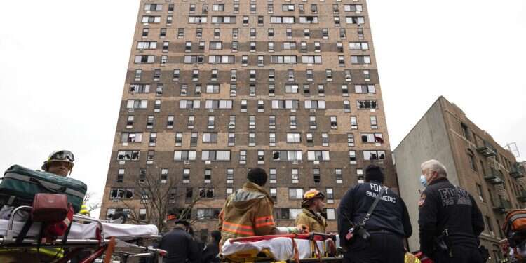 Emergency personnel at the scene of a fatal fire at an apartment building in the Bronx on Jan. 9, 2022
19 dead, including 9 children, in Bronx apartment fire