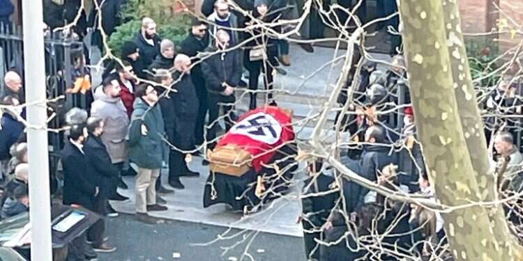 A picture made available by the Italian online news portal Open shows people gathered around a swastika-covered casket outside St. Lucia Church, in Rome on Jan. 10, 2022 Rome diocese offended over Nazi flag at neo-fascist's funeral