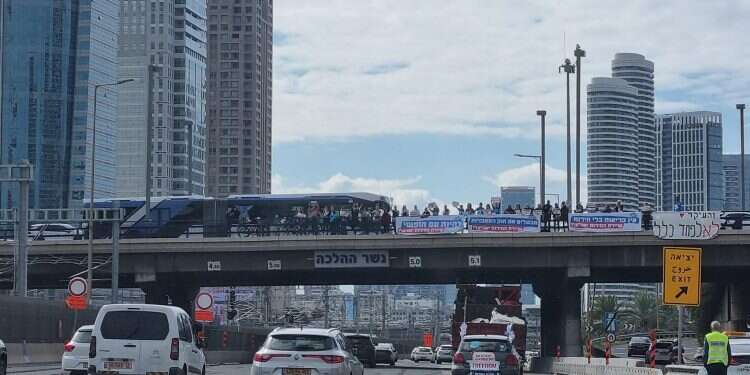 The Israeli Convoy for Freedom passes under Halacha Bridge in Tel Aviv on Monday, February 14, 2022 Israeli 'freedom convoy' heads to Jerusalem to protest COVID mandates