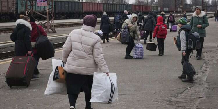 People wait for a Kyiv-bound train spread on a platform in Kostiantynivka in the Donetsk region in eastern Ukraine, Feb. 24, 2022 Ukrainian, Russian teams launch talks amid reports hit squads 'hunting' Zelenskyy