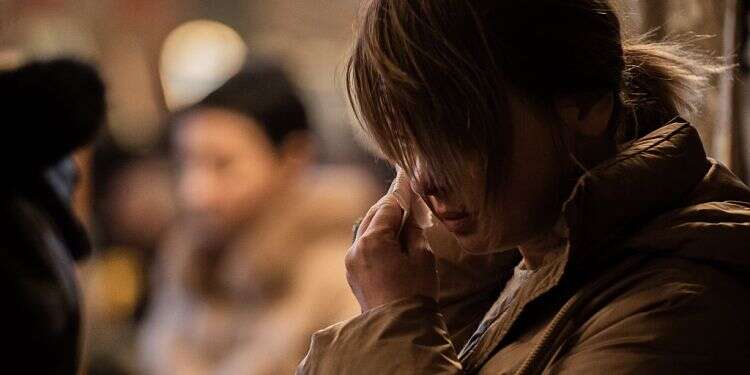 A Ukrainian refugee cries during a Sunday of forgiveness and prayer for peace in Church of the Assumption, March 6, 2022 in Nessebar, Bulgaria Ukrainian envoy to Israel decries Russian 'genocide' of his people