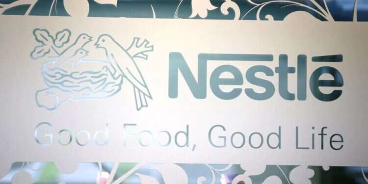 Nestle logo is pictured on the door of the supermarket of Nestle headquarters in Vevey, Switzerland, Feb. 13, 2020 Nestle, tobacco giants, Sony join move away from Russia