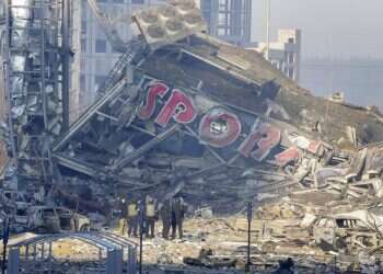 People examine the damage after shelling of a shopping center, in Kyiv, Ukraine, Monday, March 21, 2022 Knesset delegation to visit Ukraine-Hungary border; EU weighs oil embargo