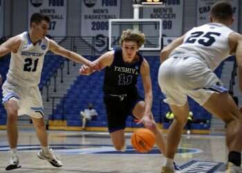 Yeshiva University's Ryan Turell (11) dribbles the ball down court while being defended by Johns Hopkins University's Carson James (21) and Lincoln Yeutter (25) in the first round of the NCAA's Division III basketball tournament, in Galloway Township, NJ, on March 4, 2022
Yeshiva U. 'Macs' end three-year streak in loss to Johns Hopkins
