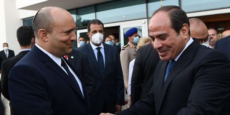 Prime Minister Naftali Bennett shakes hands with Egyptian President Abdel-Fattah al-Sissi on a visit to Egypt on Sept. 13, 2021 Report: Israel, Egypt, UAE summit born out of anger at Biden